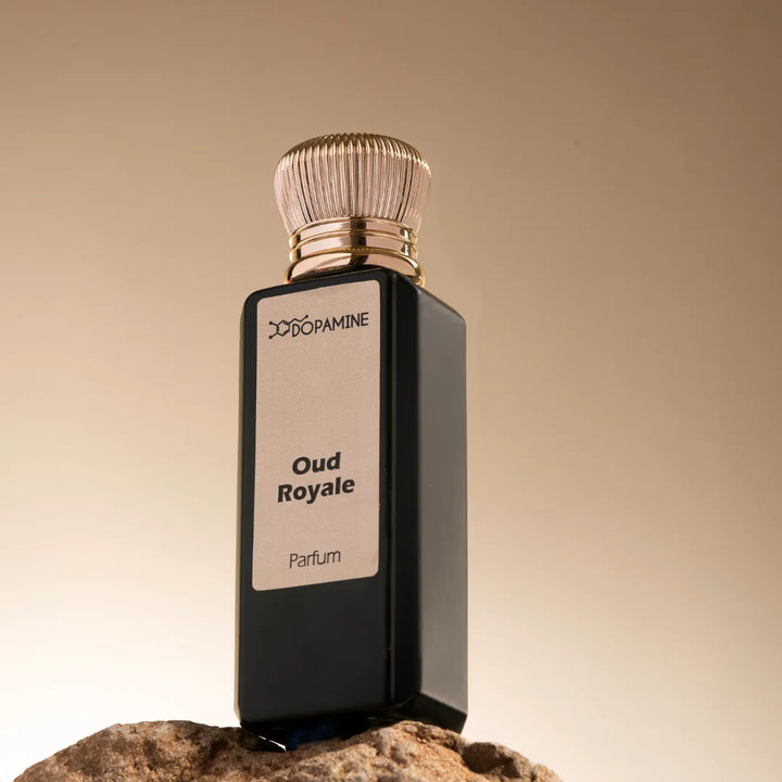 Oud Royale perfume bottle on a rock