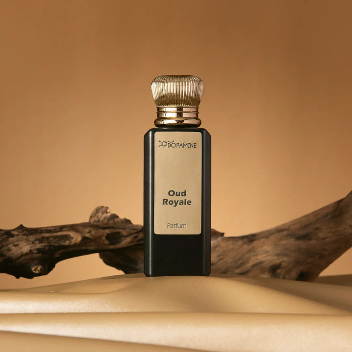 Oud Royale perfume bottle on sand with wood