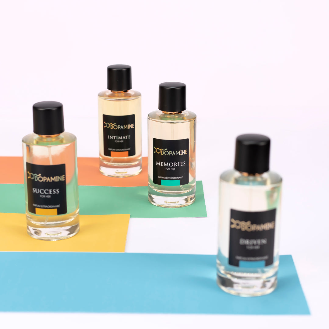 Four bottles of different variants of Dopamine women's Perfumes standing on colored strips in random order